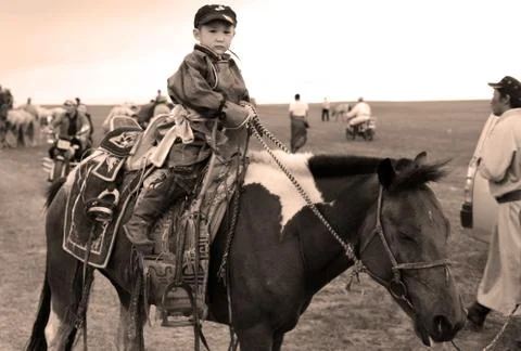 Mongolian kid on horse Foto stock