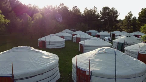 Mongolian tents side by side in a forest. Sun and lens flare. Stock Footage 258201668