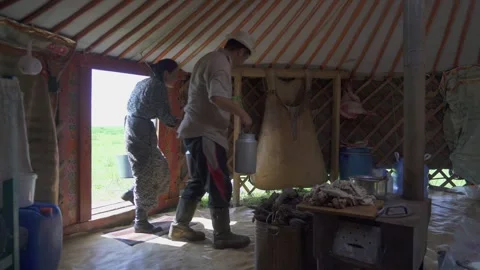 Mongolians carry and prepare mare milk inside - Airag Vessel and Leather Bag Stock Footage 340524528