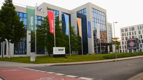 Monheim, Germany May 26th 2019: Waving flags at BASF office building Stock Footage 108642963