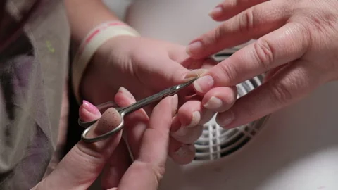 Monikure master cuts the nails of the client with scissors 스톡 동영상 167606584
