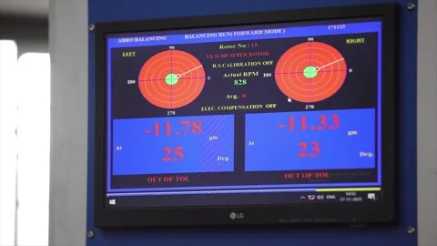 A monitor displays a high-tech "Out of Tol" warning during an balancing run for Stock Footage 328083632