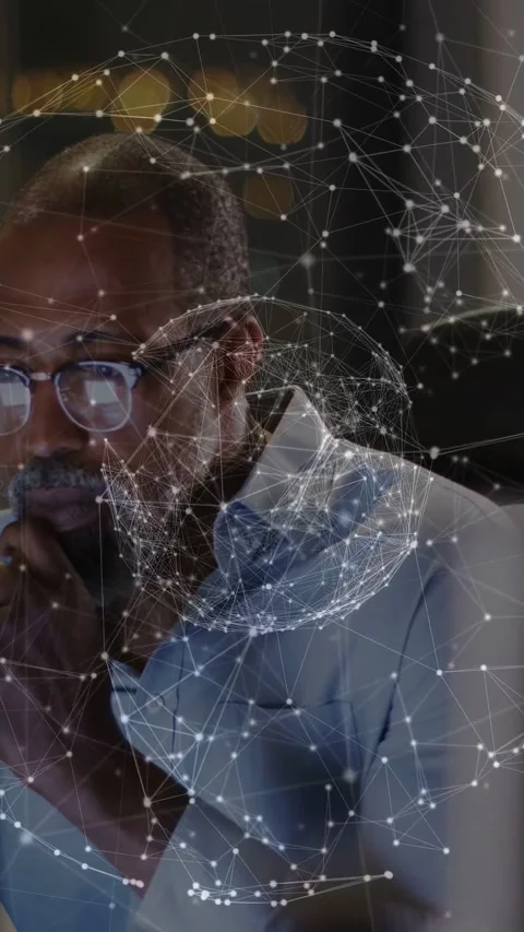 Monitor glow starting rotating network globe over frame, worker at desk leaning, Stock Footage 332806520