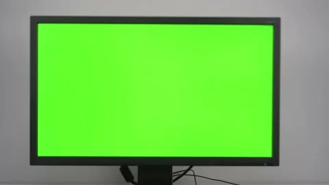 A monitor with a green screen is on the desktop in the office. Chroma Key on PC Stock Footage 231402737