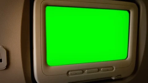 Monitor with Green Screen at the Passenger Seat Of an Airplane. Zoom In.   Video stock 128752192