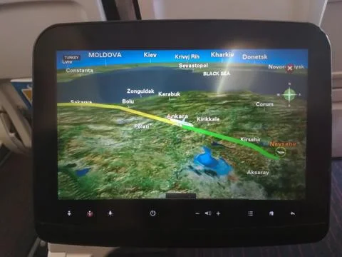 Monitor located behind the seats of the plane where it plots the route Stock Photos