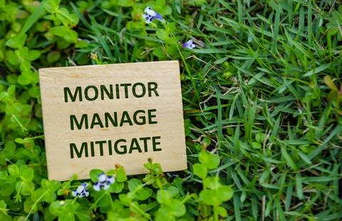 MONITOR, MANAGE, MITIGATE, Wooden cube with sustainability message on vibra.. Stock Photos