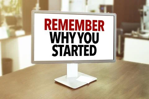 Monitor in modern office with text remember why you started on the screen i.. Stock Photos