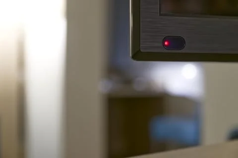 Monitor or TV power button with red light in modern interior Stock Photos