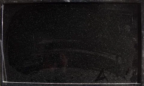 The monitor screen is covered in dust. Stock Photos