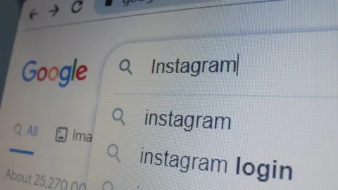 Monitor screen with a google page and typing the search term Instagram Stock Footage 235159605