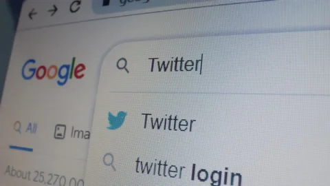 Monitor screen with a google page and typing the search term Twitter. Stock Footage 235160562