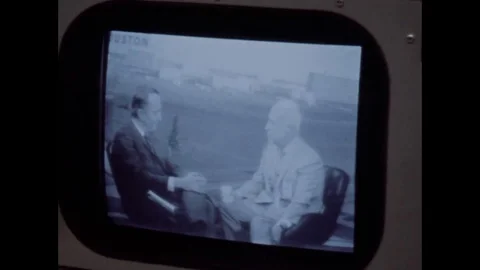 Monitor showing two men in interview in NASA control room Stock Footage 94341392