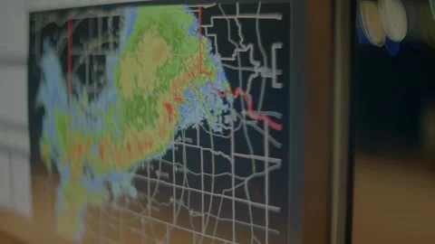 A monitor shows radar images of a storm moving Stock Footage 157464358