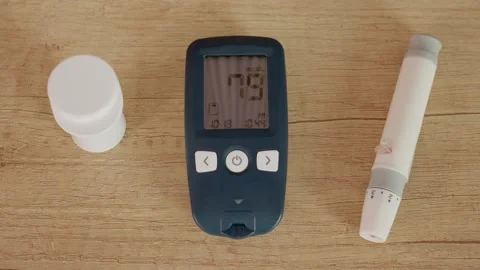 Monitoring blood sugar level with a glucometer reading 79 mg dL Stock Footage 346703879