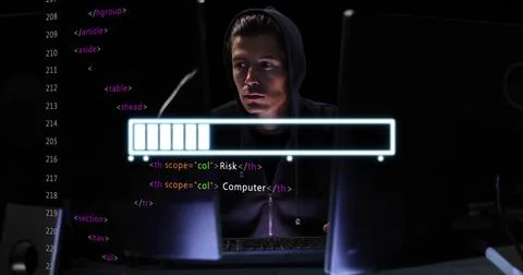 Monitoring coder wearing dark zipup hoodie with hood up in dark room, monitors 写真素材