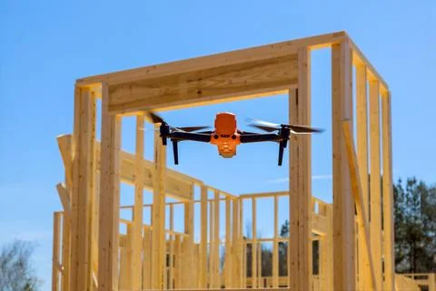 Monitoring contractor inspects construction site with a drone Stock Photos