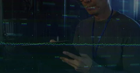 Monitoring data overlays, Korean IT tech with lanyard tapping tablet among Stock Photos