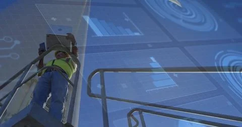 Monitoring data on tablet, smartphone technician wearing safety vest standing 스톡 사진