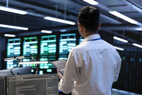 Monitoring, engineer and servers with data center operations Stock Photos