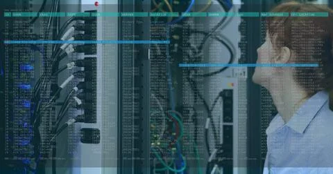 Monitoring IT tech in light blue shirt inspecting server racks with terminal Stock Photos