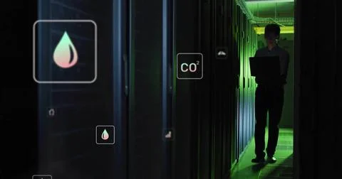 Monitoring Korean tech in long sleeves holding laptop in server aisle, hologram Stock Photos