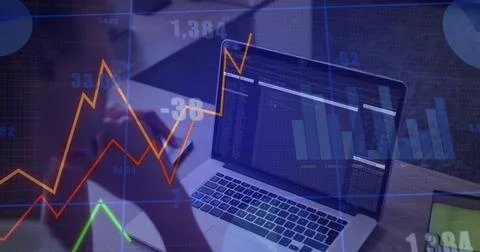 Monitoring laptop showing code and chart overlays on desk, dark sleeve forearm, Stock Photos