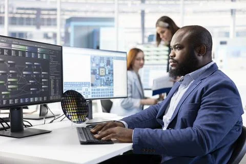 Monitoring microchip production quality, office desk and engineer Stock Photos
