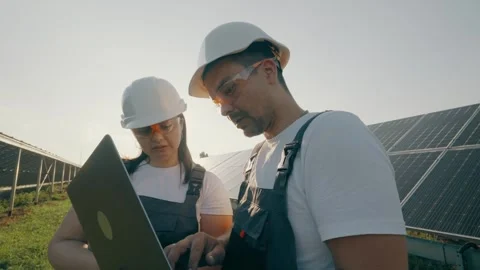 Monitoring the operation of solar panels by specialists using a laptop Video stock 261521625