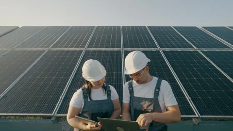 Monitoring the operation of solar panels by specialists using a laptop Video stock 273923152