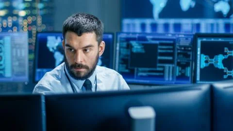 In the Monitoring Room Technical Operator Attentively Monitors Stability Stock Photos