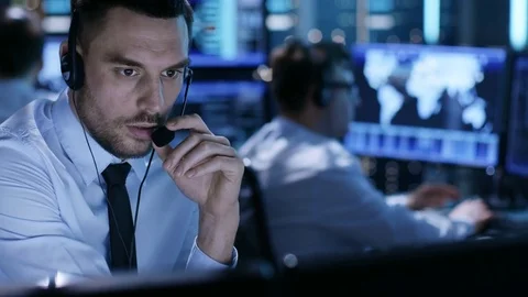 In Monitoring Room Technical Support Specialist Speaks into Headset.  Stock Footage 75004294