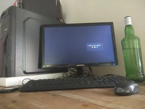Monitor,mause,keyboard and bottle. Stock Photos