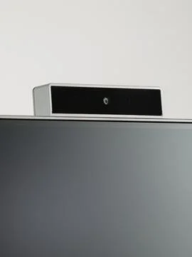 Monitor's camera is in close-up on a white background. Stock Photos