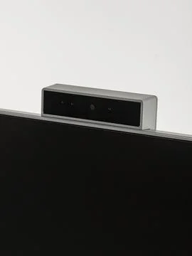 Monitor's camera is in close-up on a white background. Stock Photos