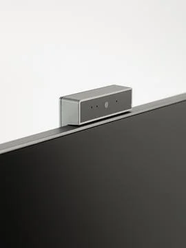 Monitor's camera is in close-up on a white background. Stock Photos
