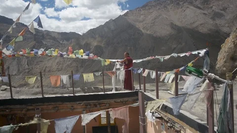 Monk And Prayer Flags in a Buddhist Monastery in Himalayas, Spiti Stock Footage 86742411