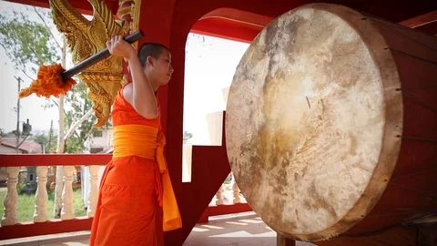 Monk beats the drum in Laos Stock Footage 104121338