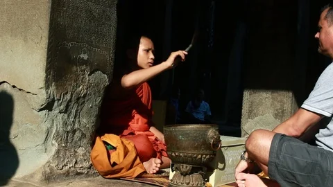 Monk blessing tourists Stock Footage 109197292