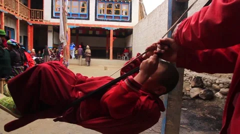 Monk boy playing on swing in Mustang Stock Footage 62388033