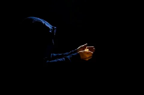 Monk with candle. Stock Photos