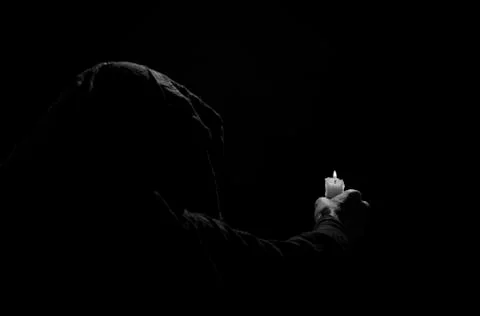 Monk with candle. Stock Photos