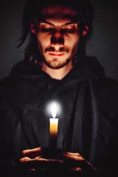 A monk with a candle Stock Photos