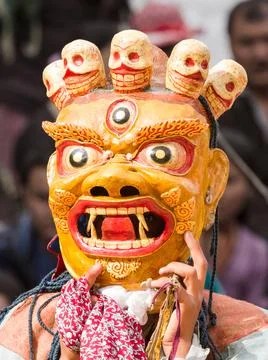 Monk in dharmapala mask performs a religious Cham Dance of Tibetan Buddhism Stock Photos