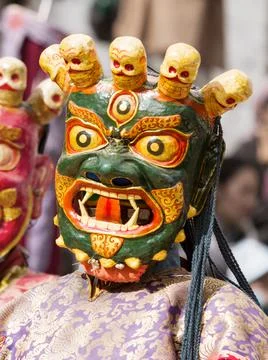 Monk in dharmapala mask performs a religious Cham Dance of Tibetan Buddhism Stockfoto's