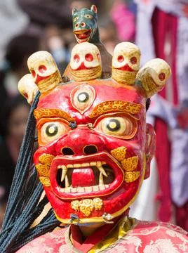 Monk in dharmapala mask performs a religious Cham Dance of Tibetan Buddhism Stock Photos