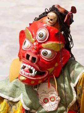 Monk in dharmapala mask performs a religious Cham Dance of Tibetan Buddhism Stock Photos