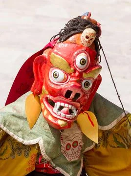 Monk in dharmapala mask performs a religious Cham Dance of Tibetan Buddhism Stock Photos