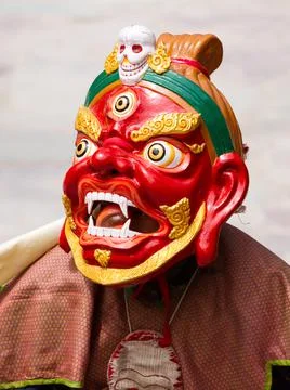 Monk in dharmapala mask performs a religious Cham Dance of Tibetan Buddhism Stock Photos
