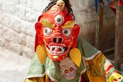 Monk in dharmapala mask performs a religious Cham Dance of Tibetan Buddhism 스톡 사진
